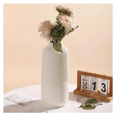Image de Vase en céramique blanche, décorée de motifs en relief, idéale pour les fleurs