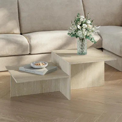 A modern living room setting with a couch and a two-tiered coffee table.