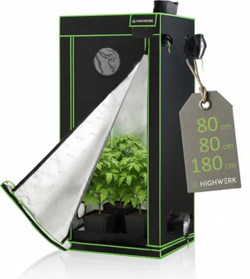A black and green grow tent with its front flap partially open, revealing plants inside. A cardboard tag with dimensions is attached to the side.