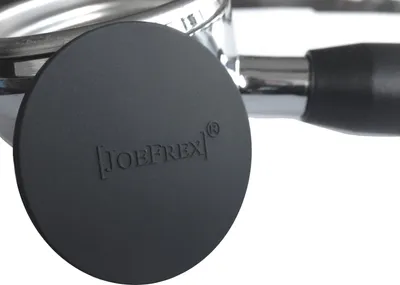 Close-up of a black circular cap with embossed text and a silver metal handle attached.