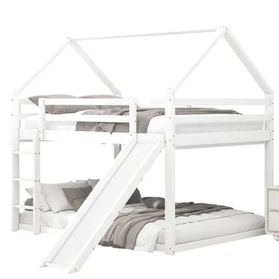A white bunk bed with a slide and a house-shaped frame, set against a white background.