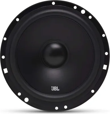 A close-up, front-facing view of a black JBL speaker. The speaker has a prominent central cone and a textured outer rim with mounting holes. The JBL logo is visible in white on the lower part of the cone.