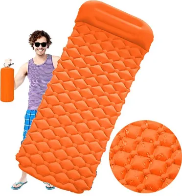 A man is holding an orange inflatable sleeping mat.