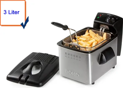 A stainless steel deep fryer with a basket of french fries inside, and a detached lid.