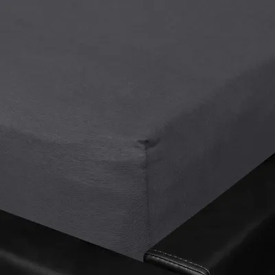 A close-up shot of a dark gray fitted sheet on a black bed frame.