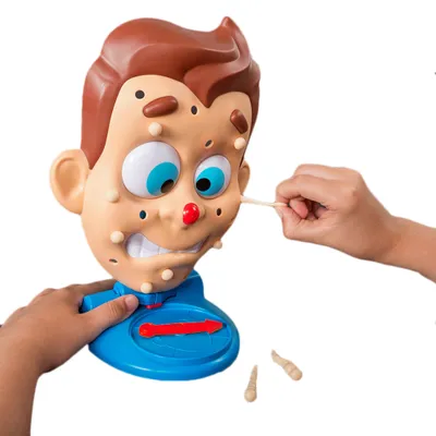 A close-up shot of a toy face with pimples being squeezed by hands.