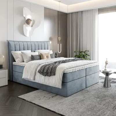 A modern bedroom with a blue upholstered bed.