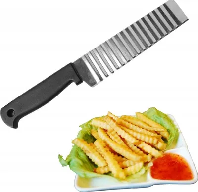 A crinkle-cut knife and a plate of french fries with dipping sauce.