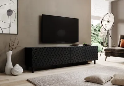 A modern living room with a TV stand and television.