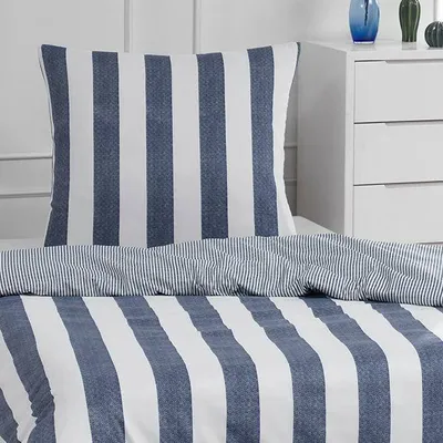 A close-up view of a striped pillow and duvet cover set on a bed.