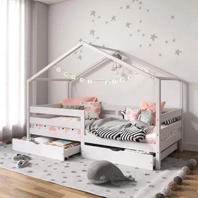 A child's bedroom with a white house-shaped bed.