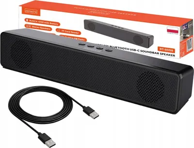A black soundbar speaker with a USB-C cable in front of its packaging.