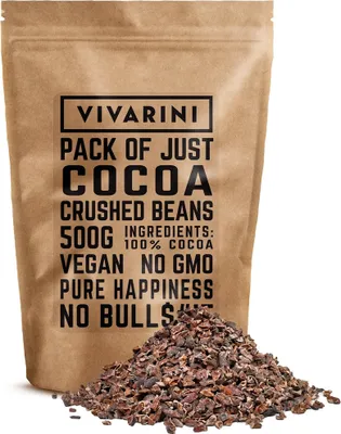 A bag of cocoa crushed beans with a pile of beans in front.