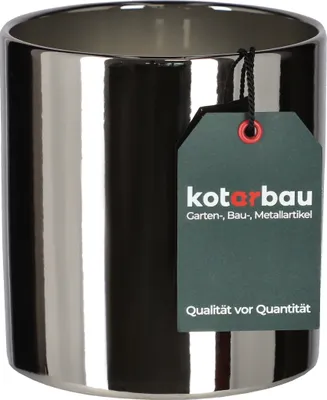 A shiny silver cylinder pot with a dark green tag attached.