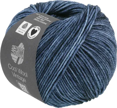 A ball of blue and gray variegated yarn with a label wrapped around it.