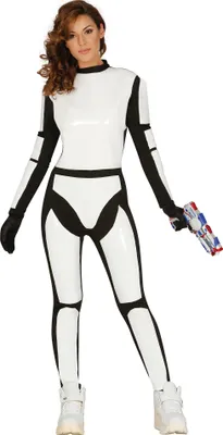 A woman is posing in a white and black futuristic costume, holding a toy gun.