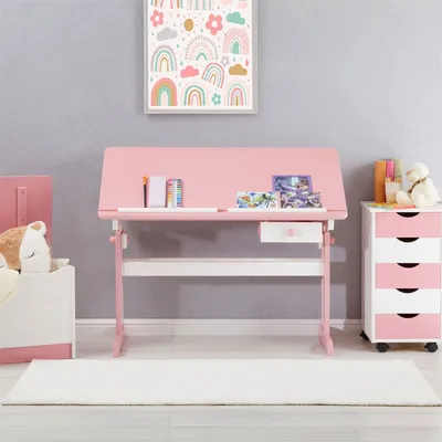 A child's pink and white desk with a shelf and drawer, set up in a room with a rug and a storage bin.