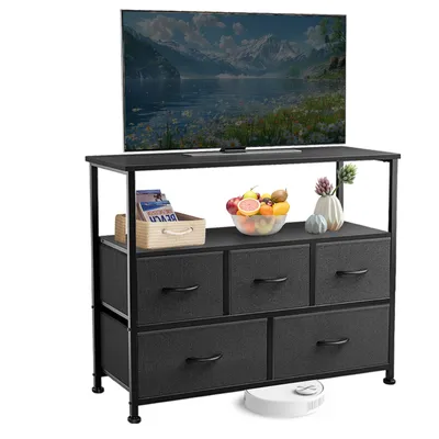 A TV stand with drawers and a television on top, along with decorative items.