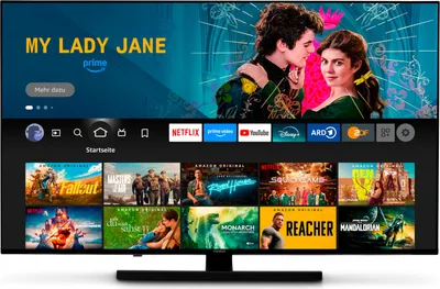 A television screen displaying a streaming service interface with various movie and TV show posters, along with app icons.