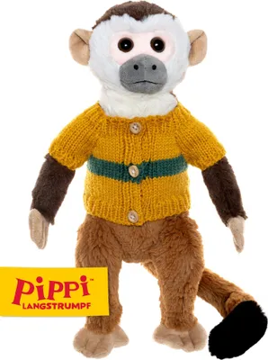 A stuffed toy monkey wearing a sweater.