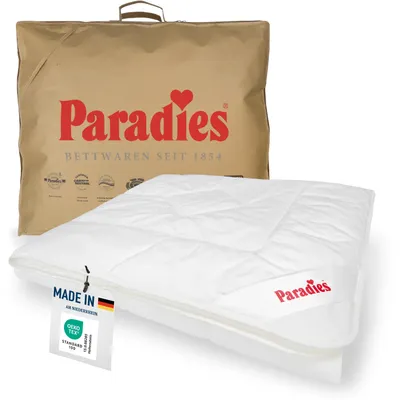 A white duvet is shown next to its brown packaging bag, both featuring the Paradies brand.