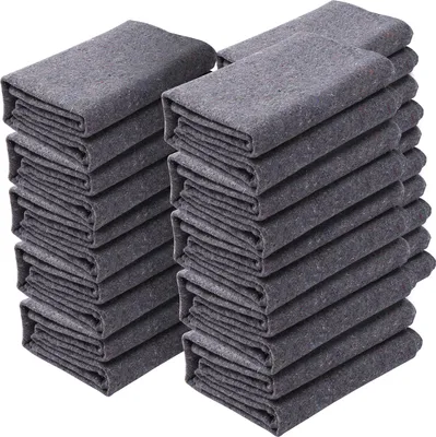Stacks of folded gray moving blankets.