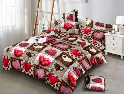 A bed with a heart-patterned duvet and pillows.