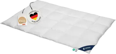 A white duvet is laid out on a white background, with tags attached to one corner.