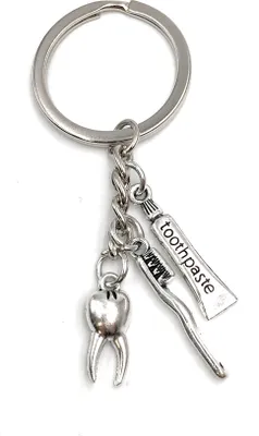 Produktbild von Onwomania Schlüsselanhänger Zahn Zahnbürste Zahnfee Zahnpasta Pflege Metall Anhänger Charm
