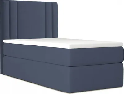 A dark blue bed with a white topper is shown against a white background.