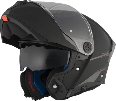 A black flip-up motorcycle helmet with a tinted visor and an internal sun visor.