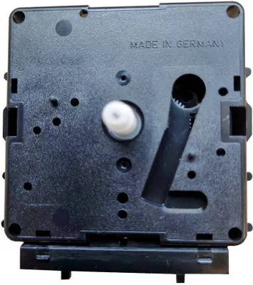 The back of a black clock movement mechanism.