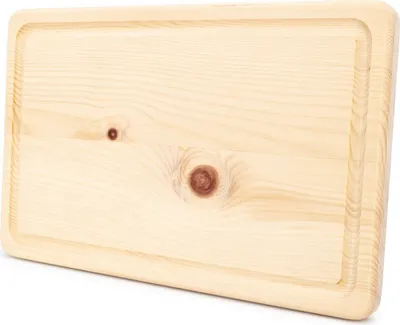 A close-up, top-down view of a wooden cutting board with a subtle groove around the edge.