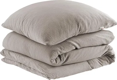 A stack of folded bedding, including a pillow and a duvet cover, on a white background.