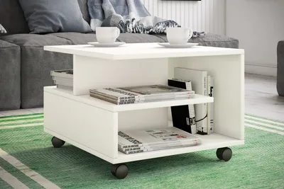 A white coffee table with storage is placed on a green rug in a living room setting, next to a gray sofa.