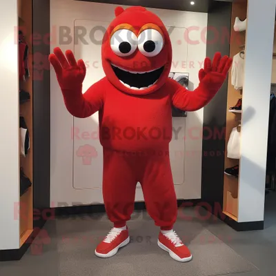 Productafbeelding van Rode Cyclops mascotte REDBROKOLY kostuum karakter gekleed met een joggingbroek en wanten