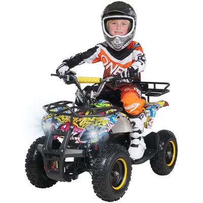A child wearing riding gear sits on a toy quad bike.