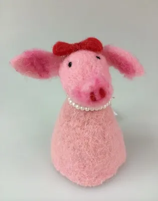 A felted pig figurine with a red bow and pearl necklace.