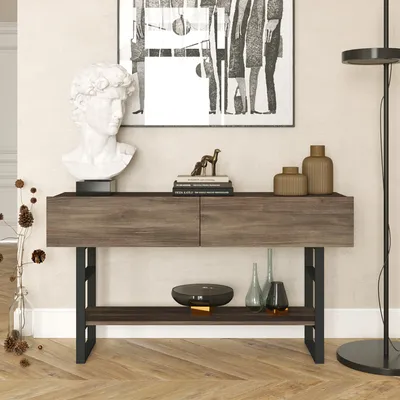A console table with decorative items and artwork in a room.