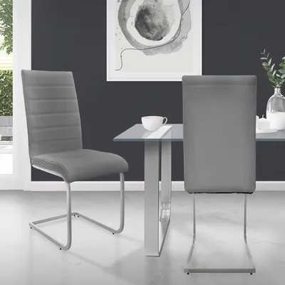 Two dining chairs are shown next to a glass-topped dining table in a modern dining room setting.