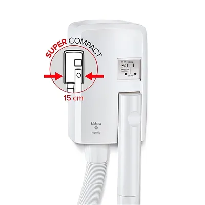 A white wall-mounted hairdryer with a hose attachment, featuring a circular graphic indicating its compact size.