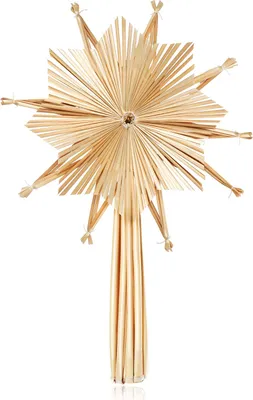 A straw star Christmas tree topper against a white background.