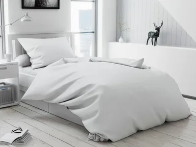 A neatly made bed with white bedding in a bright, modern room.