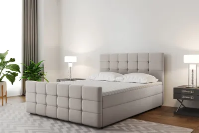 A bedroom scene featuring a large boxspring bed.