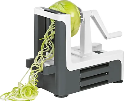 A spiralizer with a head of cabbage attached, creating spiralized vegetable strands.