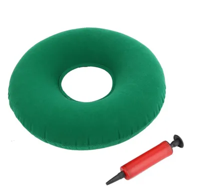 A green inflatable ring cushion and a red hand pump are shown against a white background.