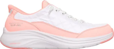 A side view of a white and pink Skechers slip-on shoe against a white background.