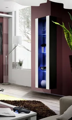 A modern living room with a tall, narrow display cabinet illuminated by blue LED lights.