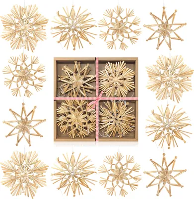 A collection of straw star ornaments arranged in a grid and scattered around it.