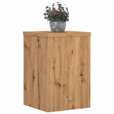 A wooden cabinet with a potted plant on top.